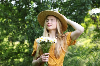 Photo of Beautiful woman with bouquet of wildflowers in forest