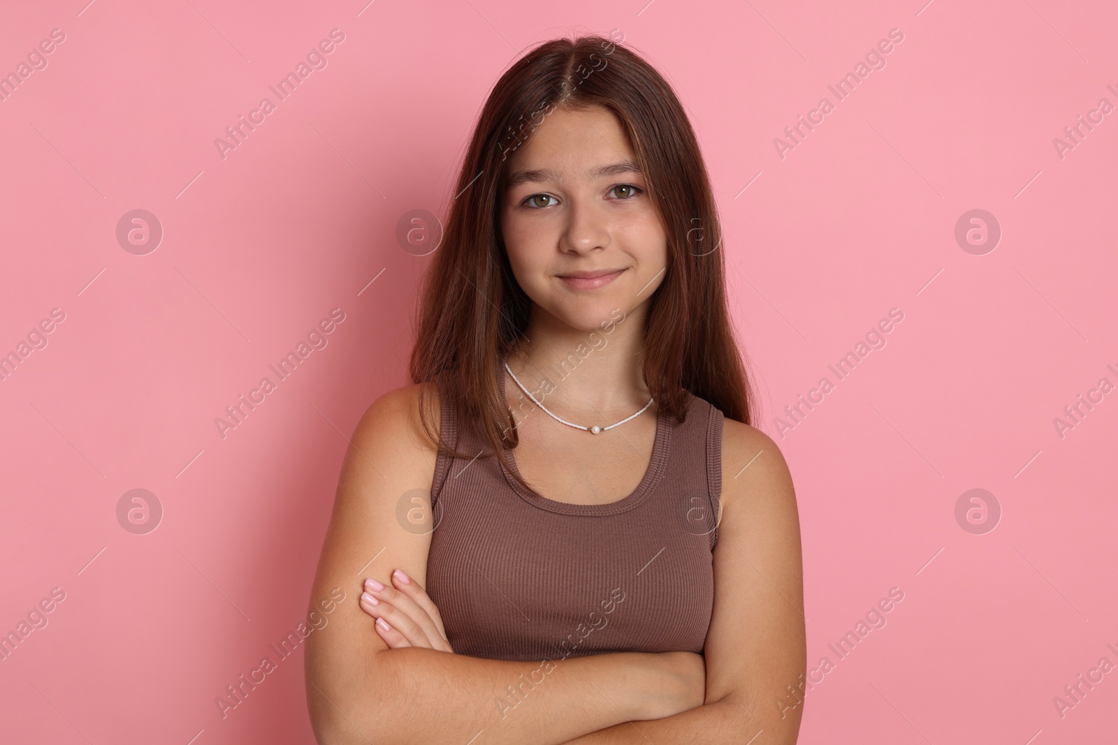 Portrait of teenage girl on pink background Photo of Portrait of teenage girl on pink background