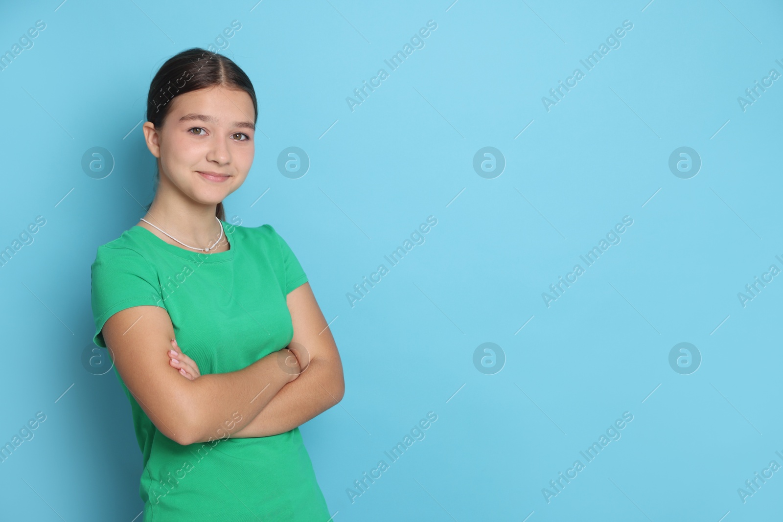 Portrait of teenage girl on light blue background, space for text Photo of Portrait of teenage girl on light blue background, space for text