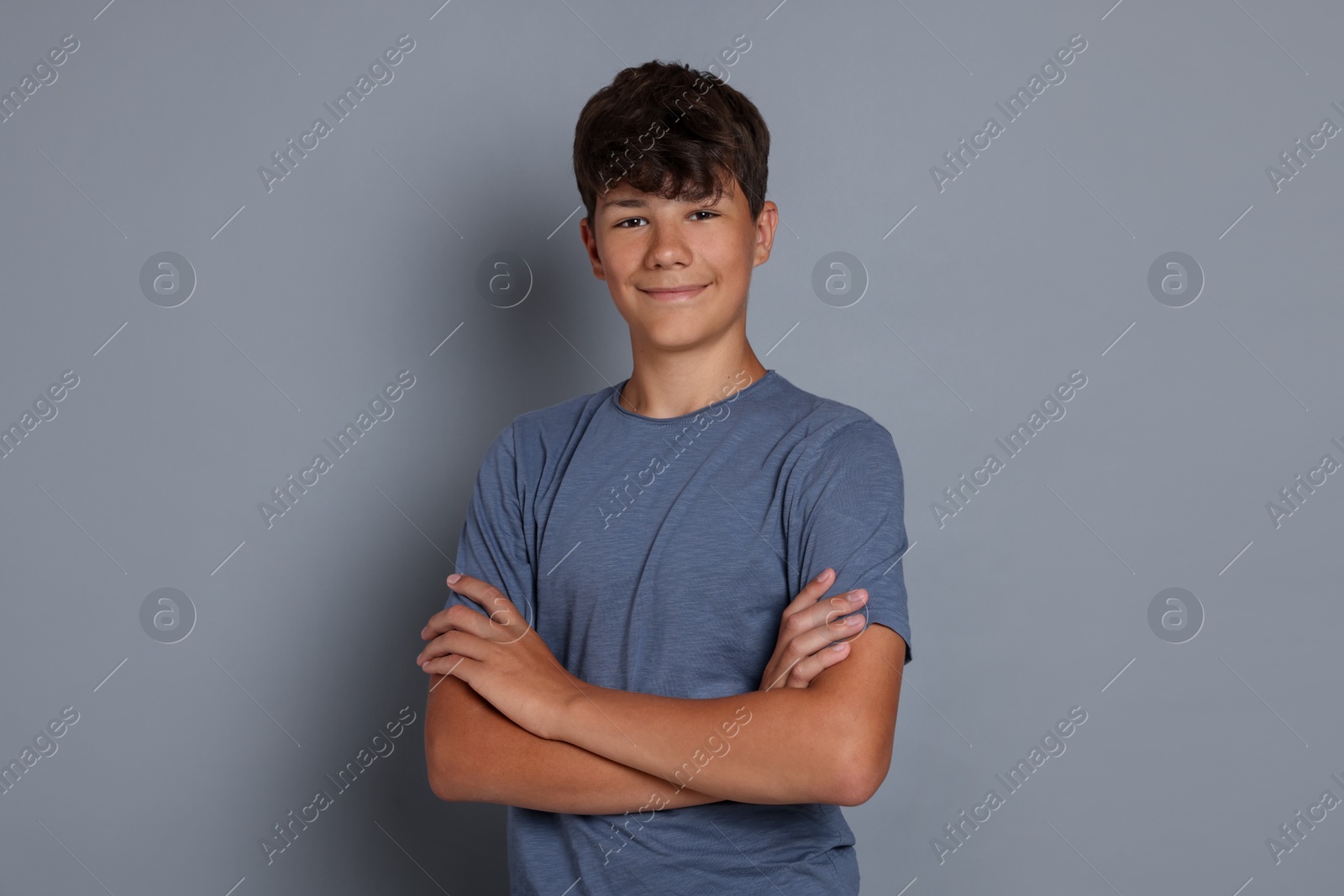 Portrait of teenage boy on grey background Photo of Portrait of teenage boy on grey background