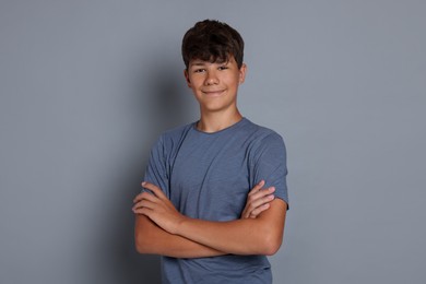 Photo of Portrait of teenage boy on grey background