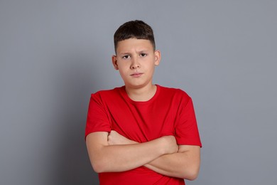 Photo of Portrait of teenage boy on grey background