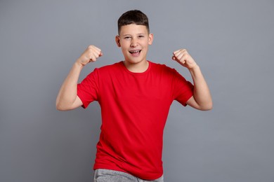 Photo of Portrait of teenage boy on grey background