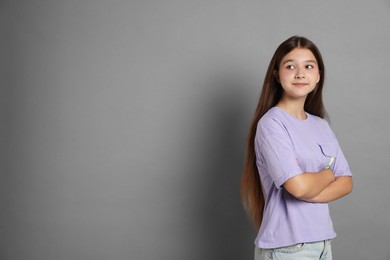 Photo of Portrait of teenage girl on grey background, space for text
