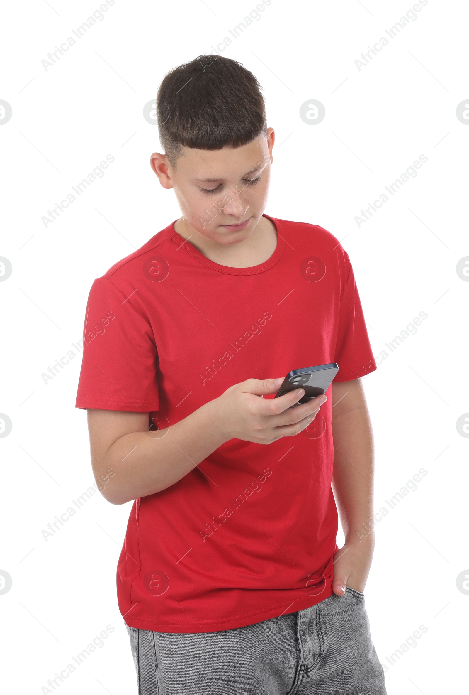 Teenage boy with smartphone on white background Photo of Teenage boy with smartphone on white background