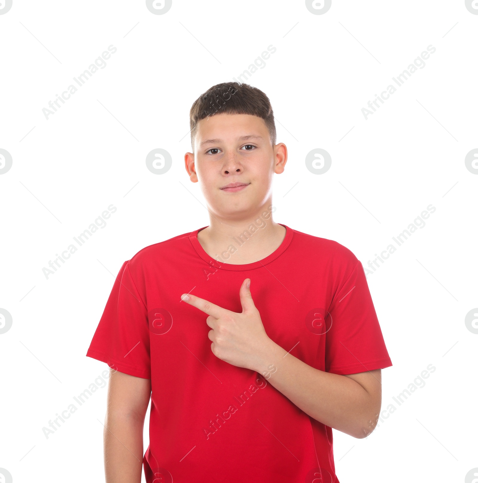 Teenage boy pointing at something on white background Photo of Teenage boy pointing at something on white background