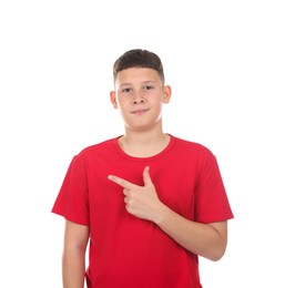 Photo of Teenage boy pointing at something on white background