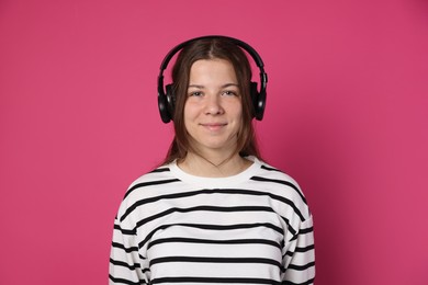 Photo of Teenage girl in headphones on crimson background