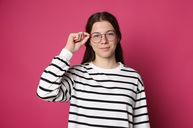 Photo of Teenage girl in glasses on crimson background
