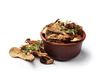 Photo of Pieces of dried mushrooms and rosemary in bowl isolated on white