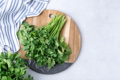 Photo of Fresh green cilantro on light table, flat lay. Space for text