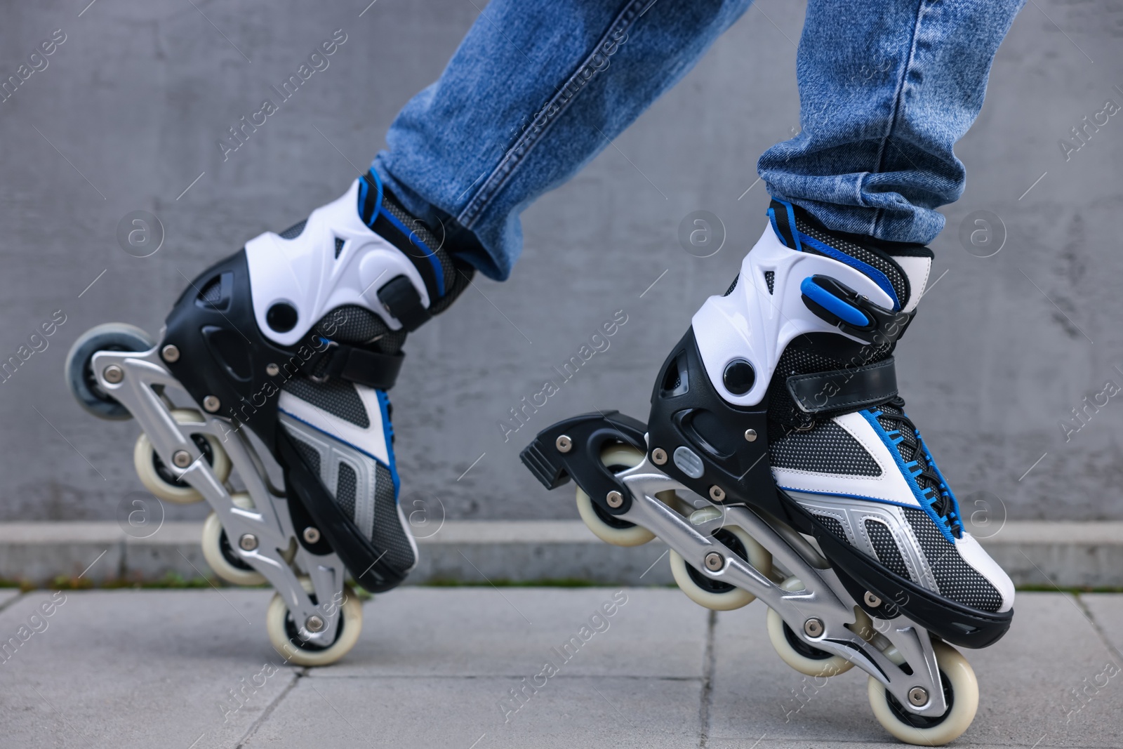 Man roller skating on city street, closeup Photo of Man roller skating on city street, closeup