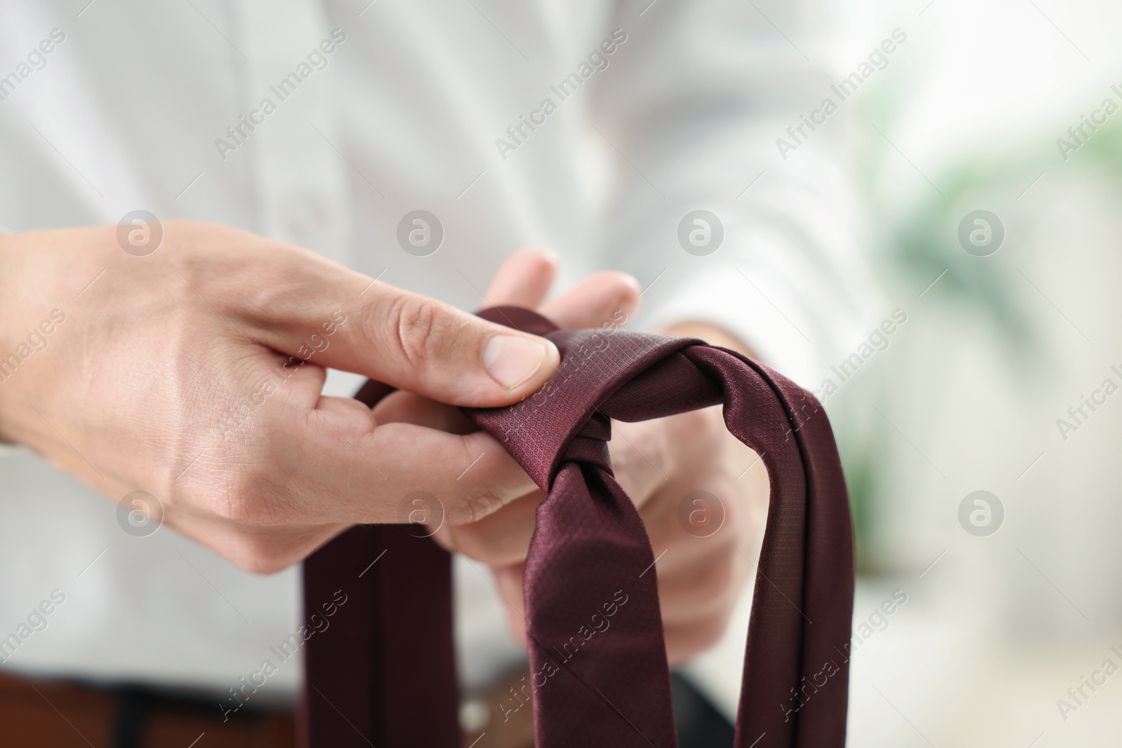 Man with stylish brown necktie at home, closeup Photo of Man with stylish brown necktie at home, closeup