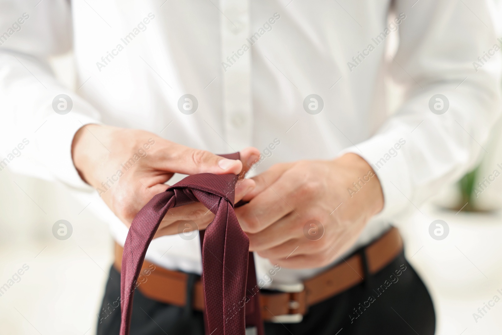 Man with stylish brown necktie at home, closeup Photo of Man with stylish brown necktie at home, closeup