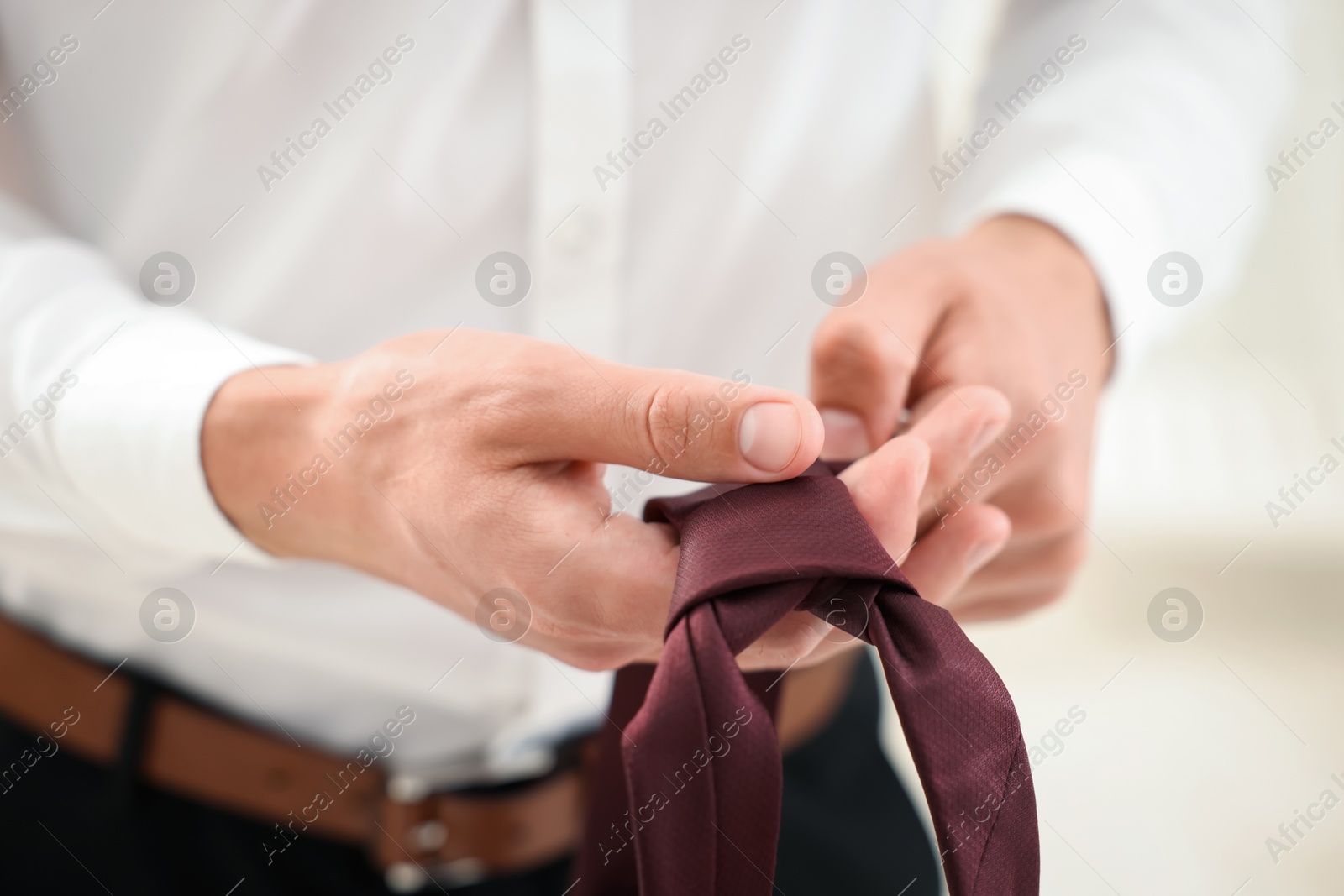 Man with stylish brown necktie at home, closeup Photo of Man with stylish brown necktie at home, closeup