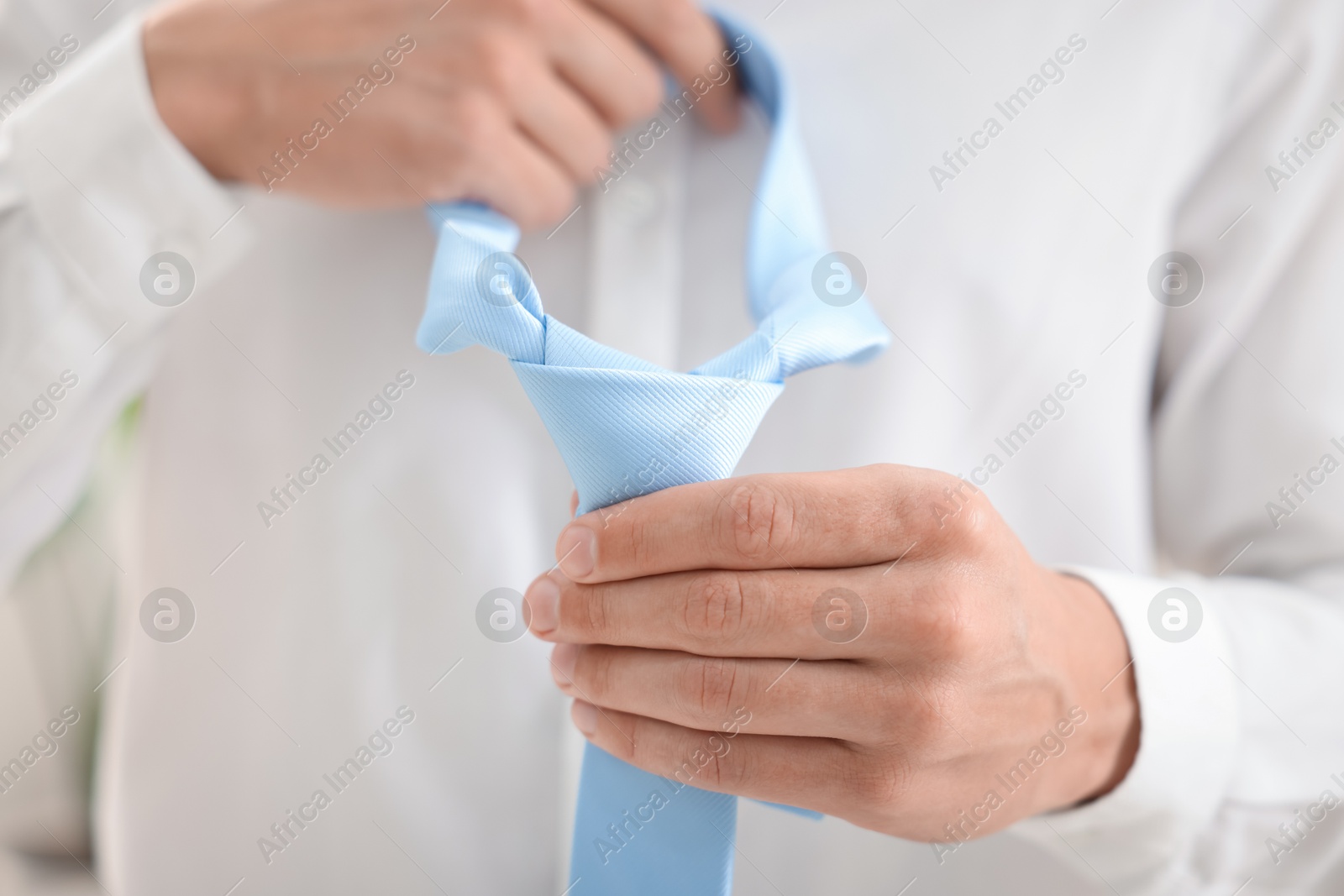 Man with stylish blue necktie at home, closeup Photo of Man with stylish blue necktie at home, closeup