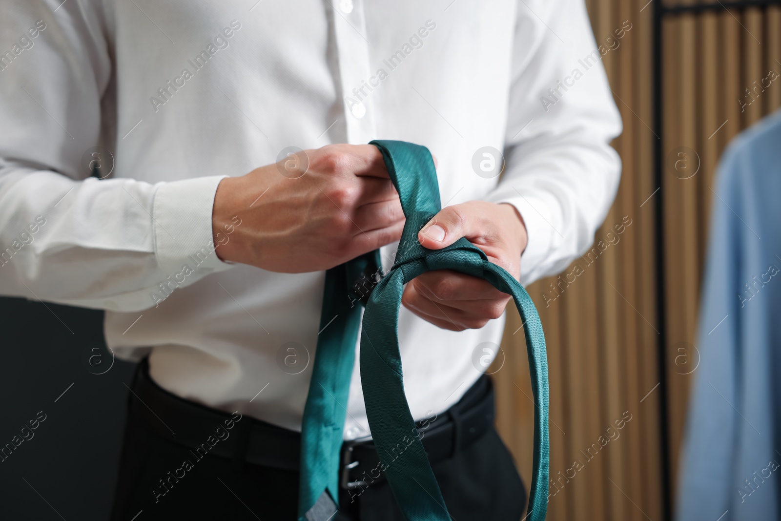 Man with stylish green necktie at home, closeup Photo of Man with stylish green necktie at home, closeup