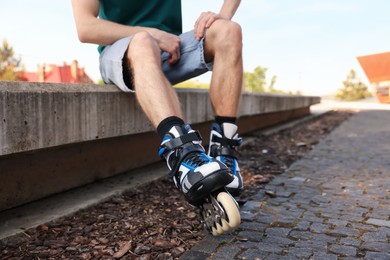 Photo of Man with roller skates on street, closeup