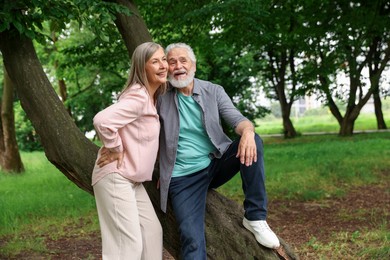 Photo of Lovely senior couple near tree in park