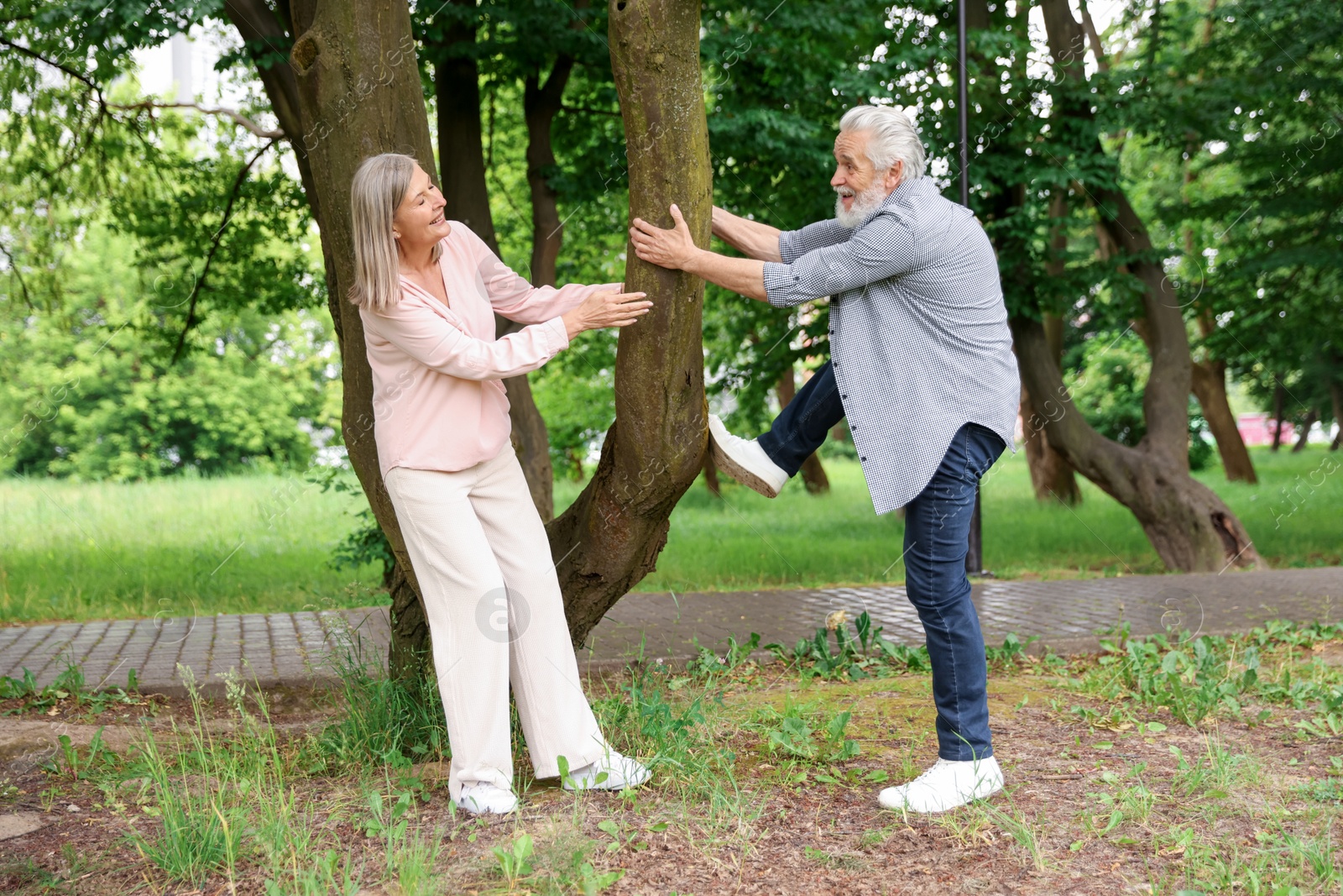 Lovely senior couple near tree in park Photo of Lovely senior couple near tree in park