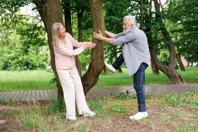 Photo of Lovely senior couple near tree in park