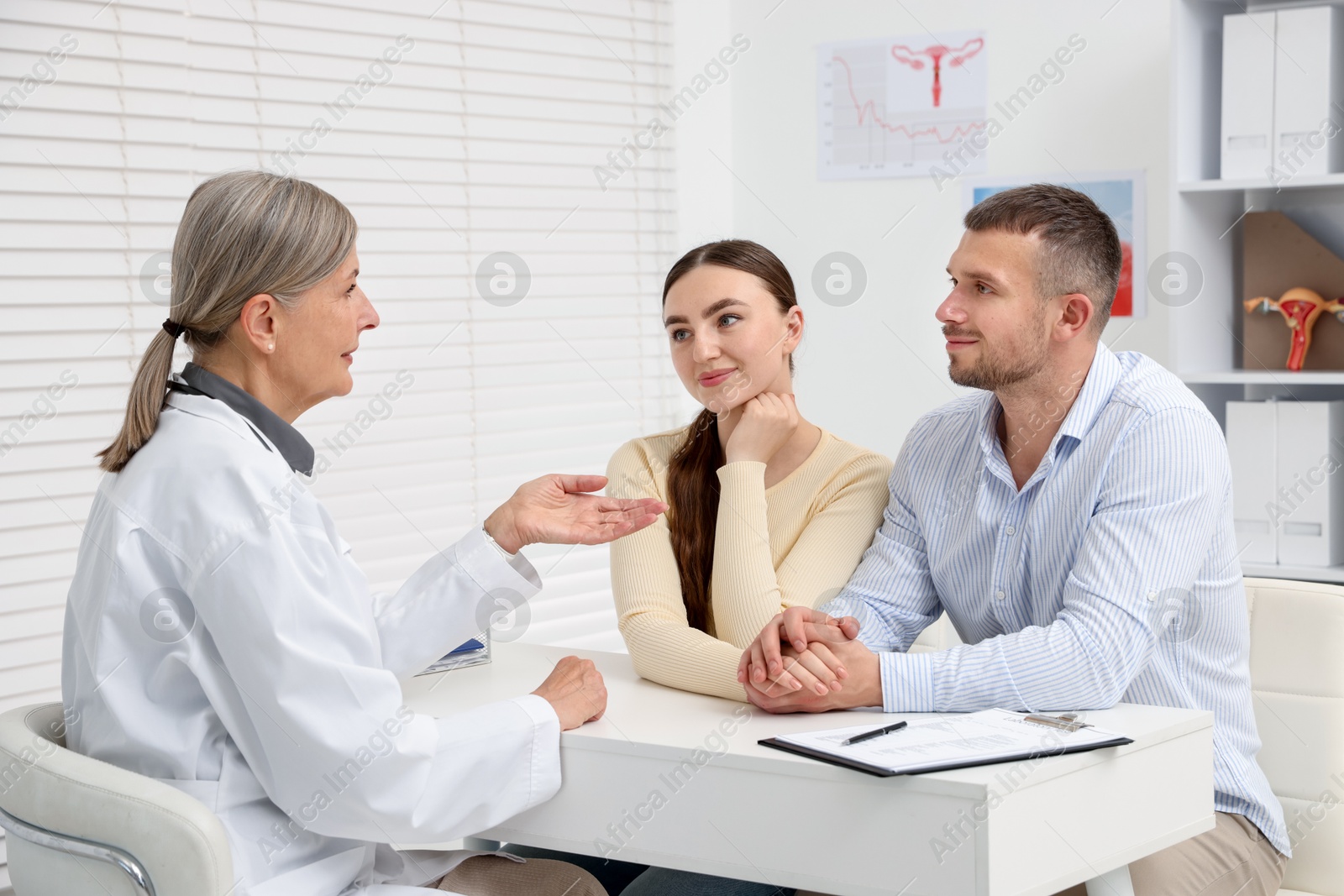 Photo of In vitro fertilization (IVF). Couple having consultation with doctor in reproductive clinic