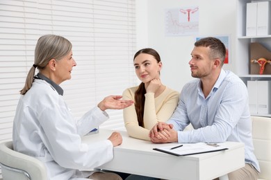 Photo of In vitro fertilization (IVF). Couple having consultation with doctor in reproductive clinic