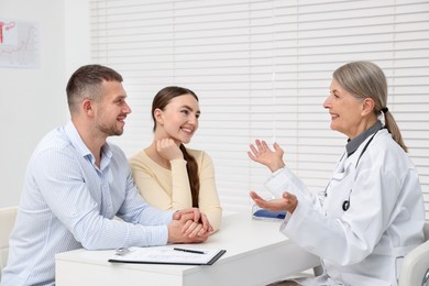 Photo of In vitro fertilization (IVF). Couple having consultation with doctor in reproductive clinic