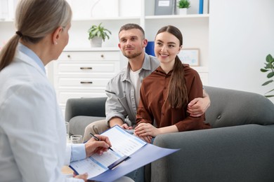 Photo of In vitro fertilization (IVF). Couple having consultation with doctor in reproductive clinic