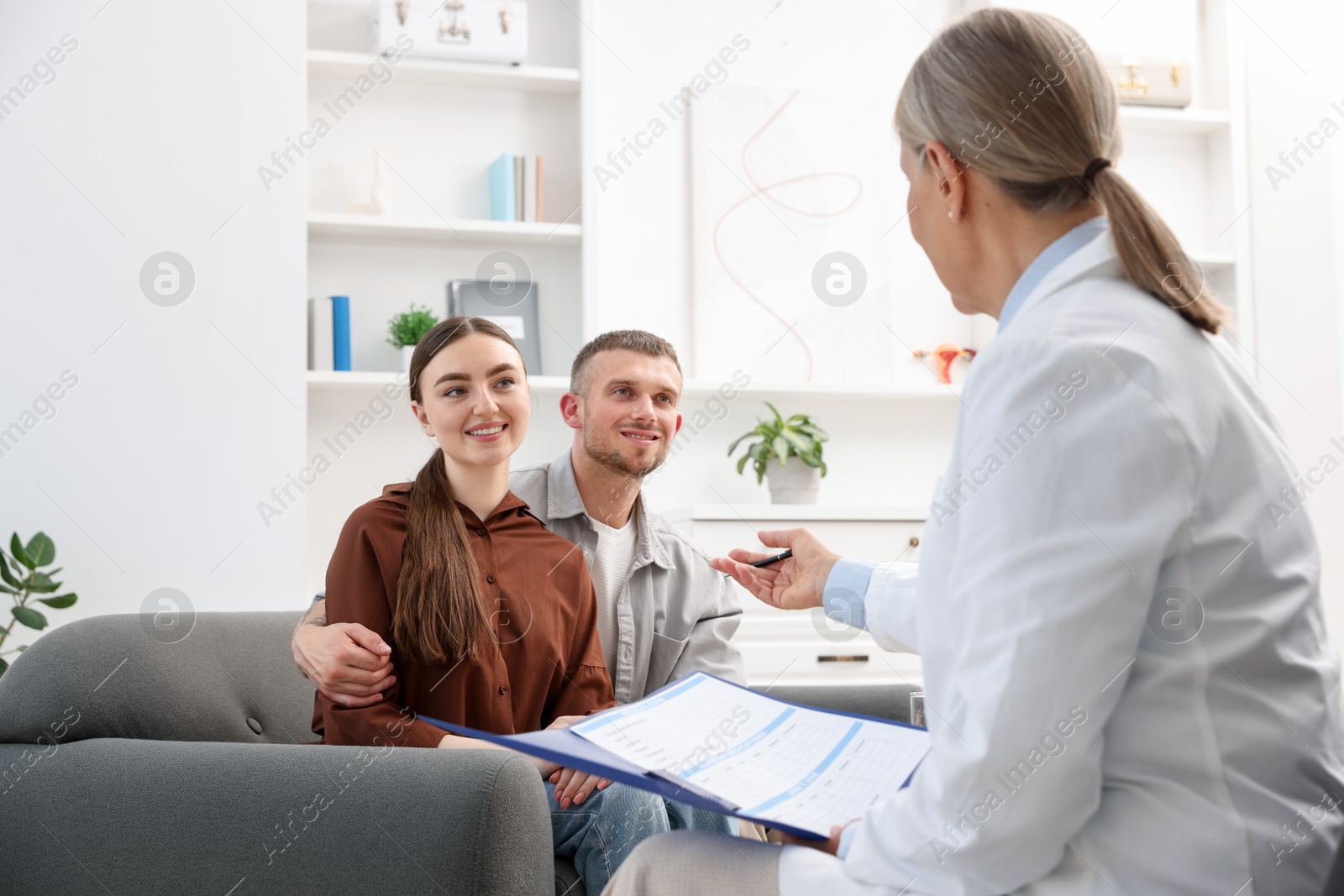 Photo of In vitro fertilization (IVF). Couple having consultation with doctor in reproductive clinic