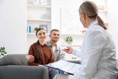 Photo of In vitro fertilization (IVF). Couple having consultation with doctor in reproductive clinic