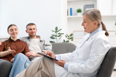 Photo of In vitro fertilization (IVF). Couple having consultation with doctor in reproductive clinic, selective focus