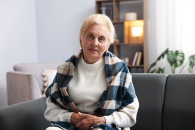 Photo of Portrait of senior woman on sofa at home