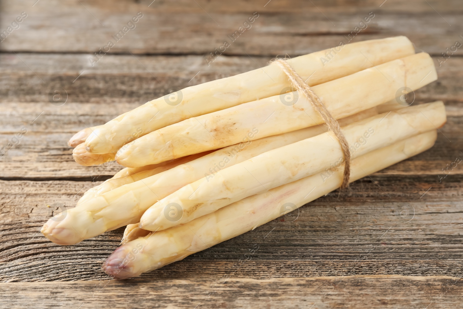 Raw white asparagus spears on wooden table, closeup Photo of Raw white asparagus spears on wooden table, closeup