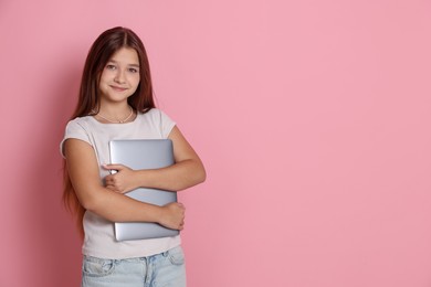 Photo of Teenage girl with laptop on pink background, space for text