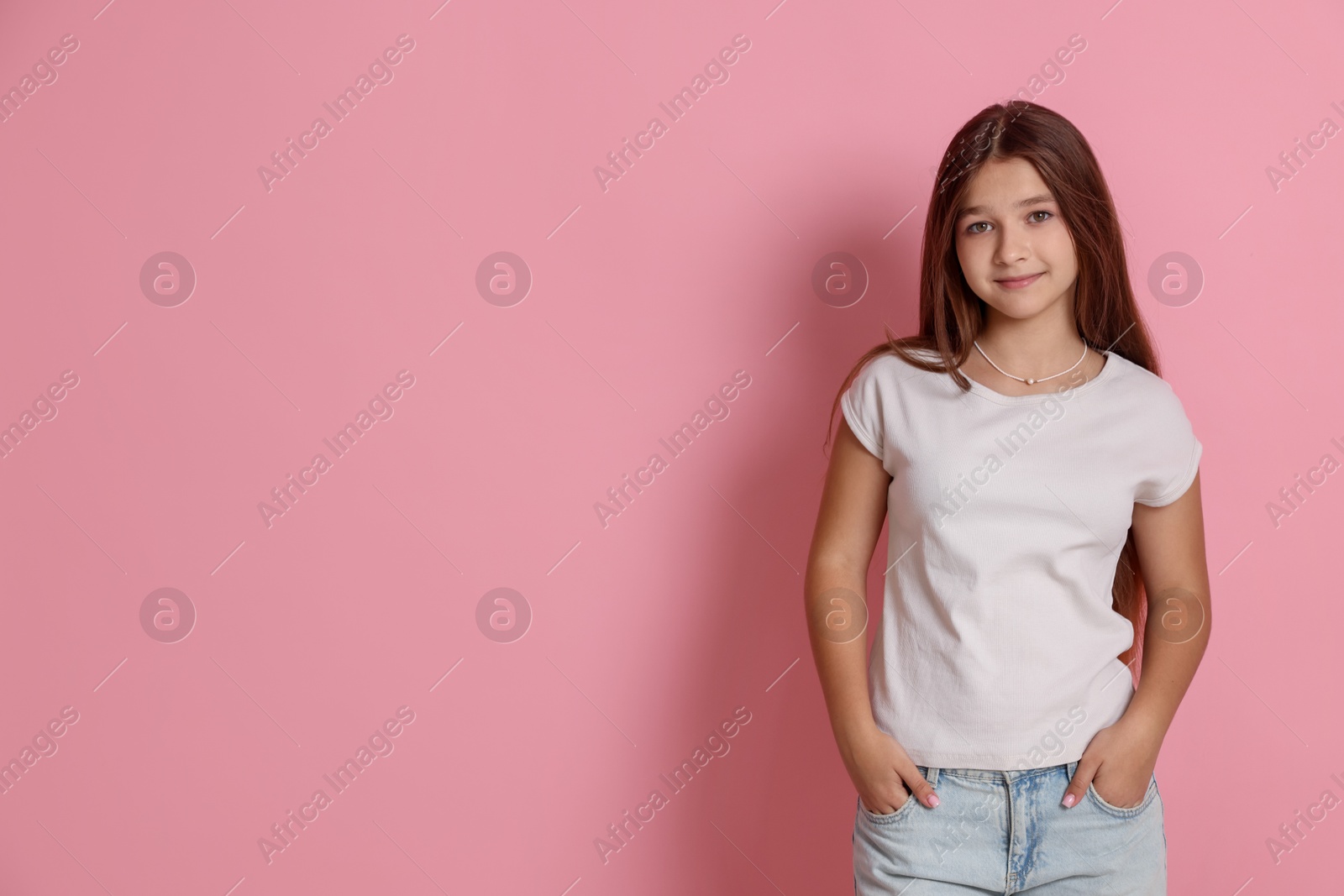 Portrait of teenage girl on pink background, space for text Photo of Portrait of teenage girl on pink background, space for text