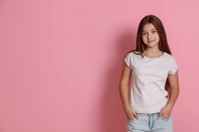 Photo of Portrait of teenage girl on pink background, space for text