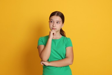 Photo of Portrait of teenage girl on orange background
