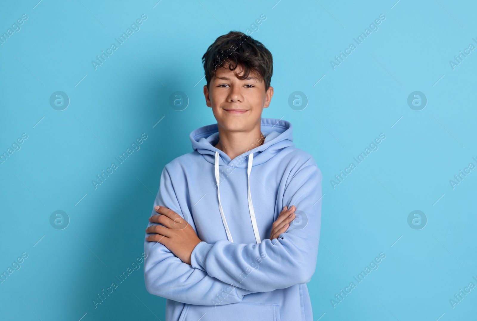 Portrait of teenage boy on light blue background Photo of Portrait of teenage boy on light blue background