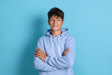 Photo of Portrait of teenage boy on light blue background