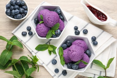 Photo of Tasty sorbet with blueberries, mint and jam on wooden table, flat lay