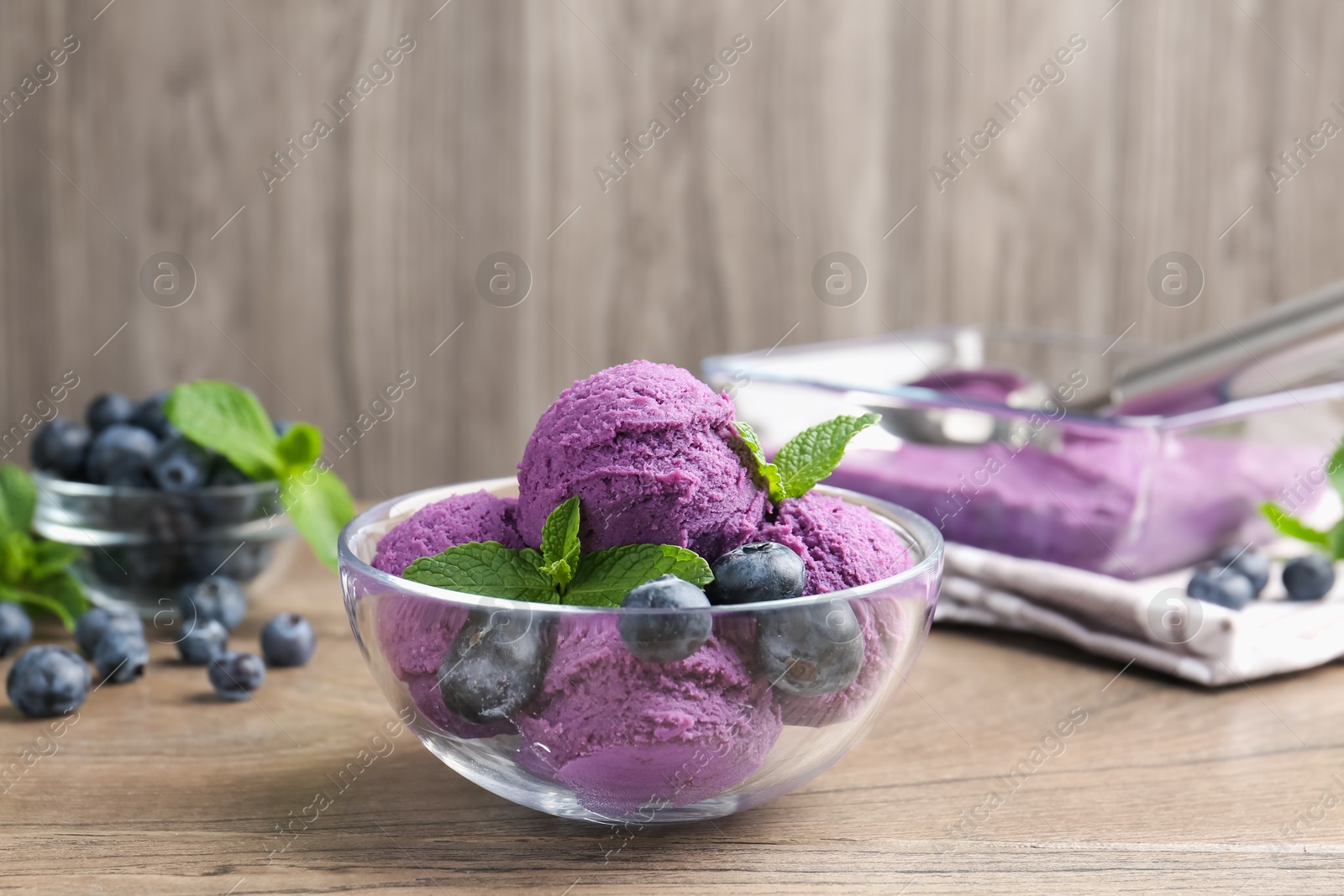 Tasty sorbet with blueberries and mint on wooden table, closeup Photo of Tasty sorbet with blueberries and mint on wooden table, closeup