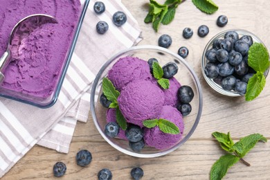 Photo of Tasty sorbet with blueberries and mint on wooden table, flat lay