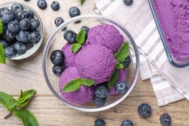 Photo of Tasty sorbet with blueberries and mint on wooden table, flat lay