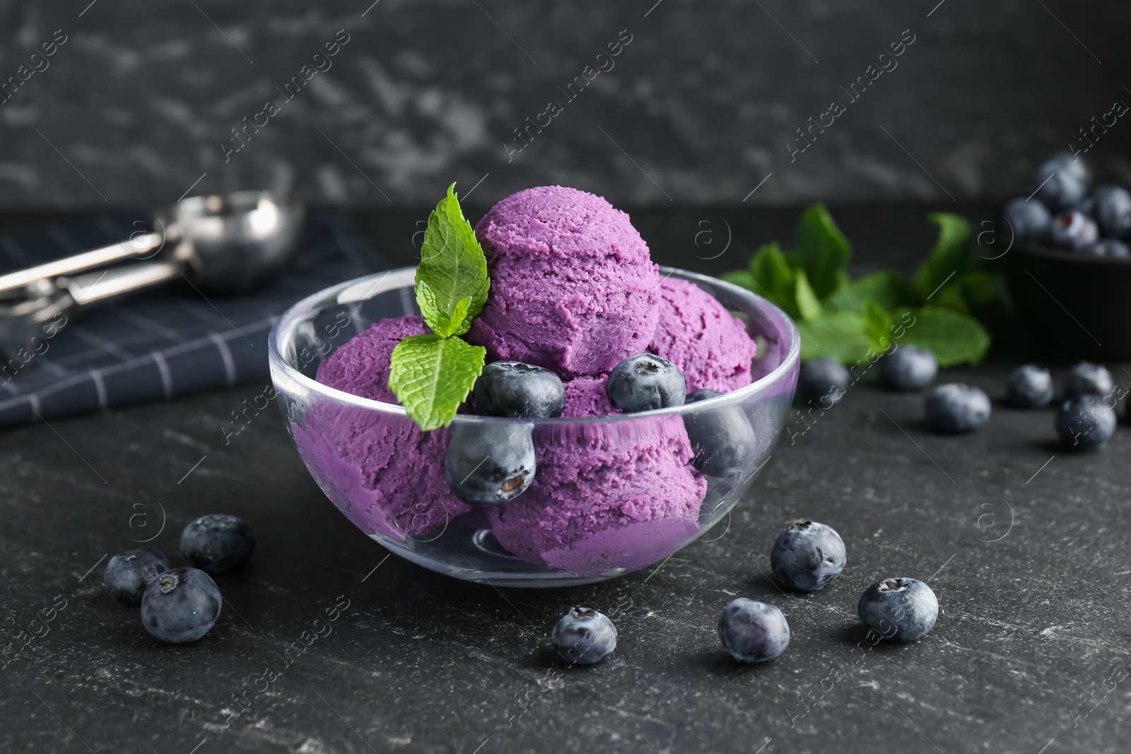 Tasty sorbet with blueberries and mint on black table, closeup Photo of Tasty sorbet with blueberries and mint on black table, closeup