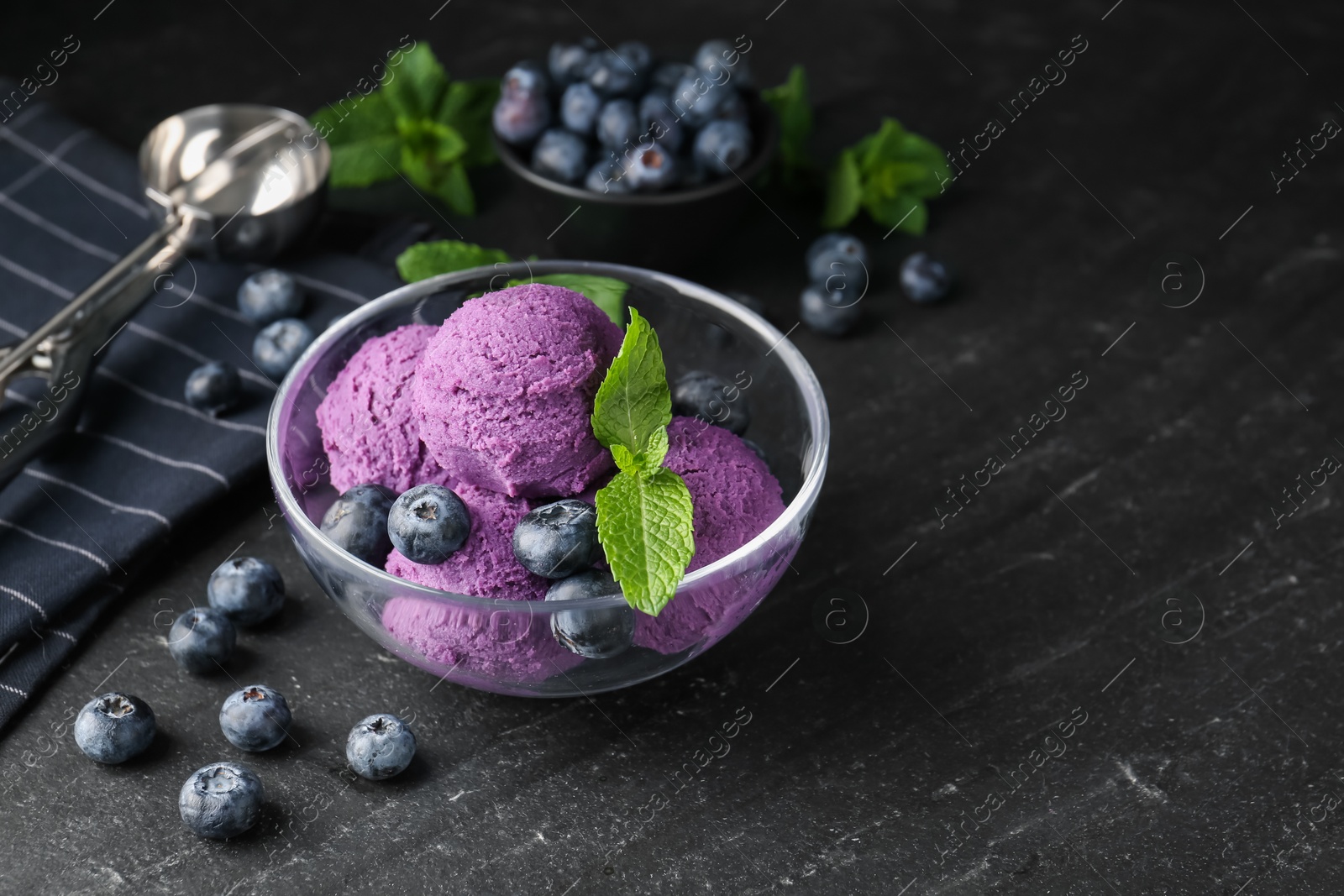 Tasty sorbet with blueberries and mint on black table, closeup. Space for text Photo of Tasty sorbet with blueberries and mint on black table, closeup. Space for text