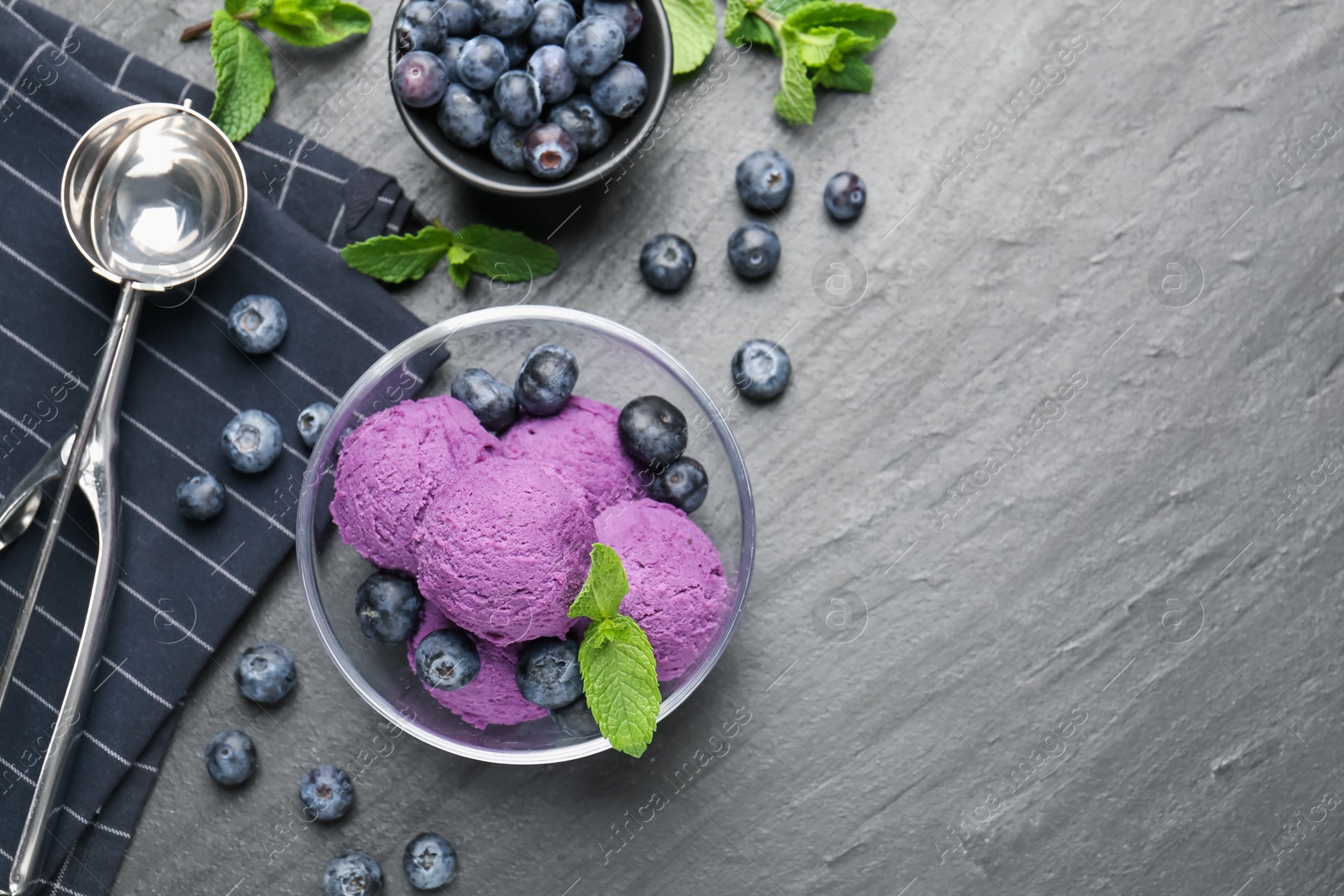 Tasty sorbet with blueberries and mint on black table, flat lay. Space for text Photo of Tasty sorbet with blueberries and mint on black table, flat lay. Space for text