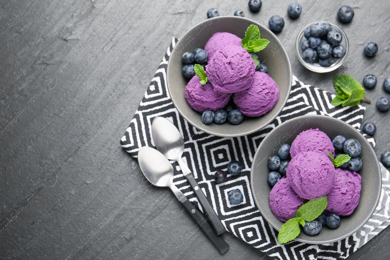 Tasty sorbet with blueberries and mint on black table, flat lay. Space for text Photo of Tasty sorbet with blueberries and mint on black table, flat lay. Space for text
