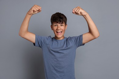 Photo of Portrait of teenage boy on grey background