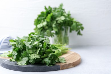 Photo of Fresh green cilantro on light table, closeup. Space for text